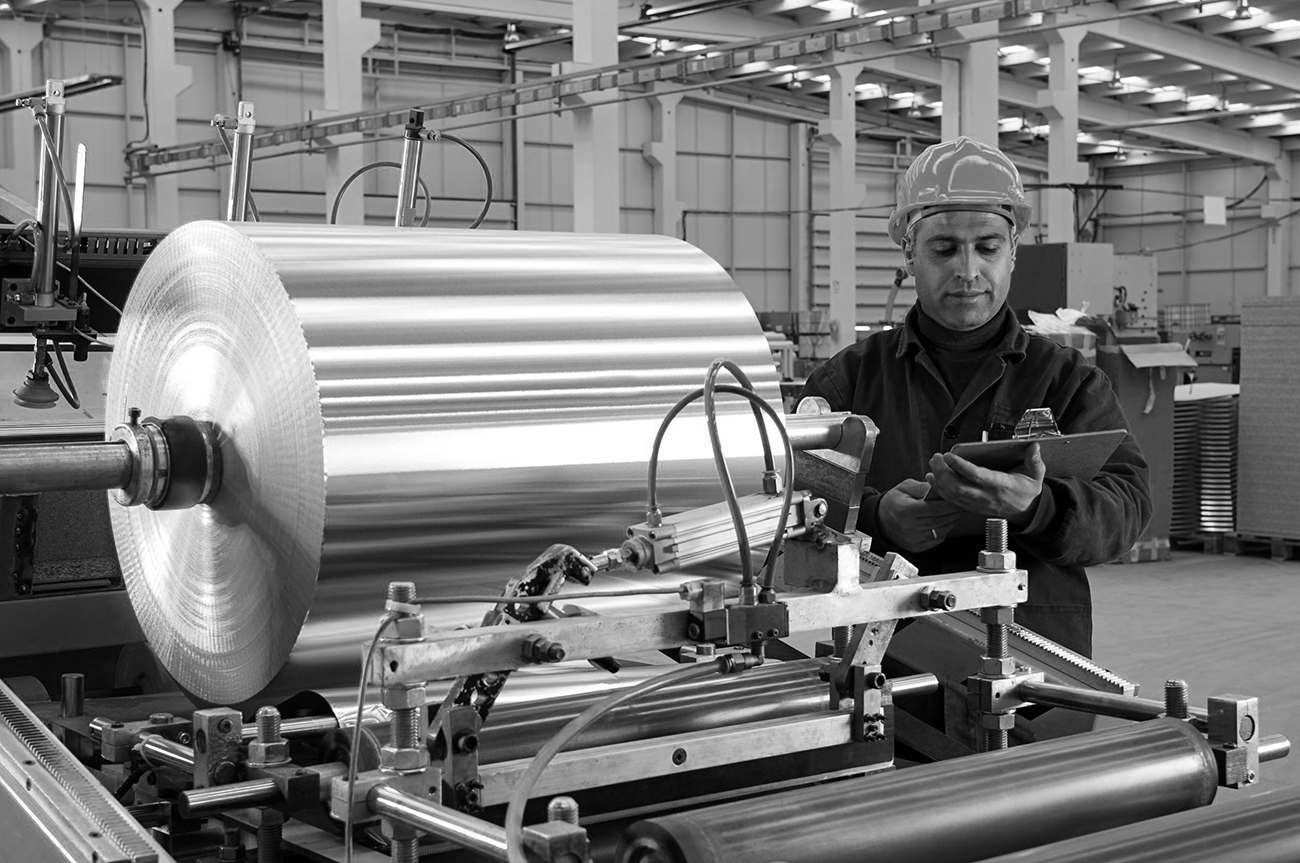 14121172 factory worker using aluminum coil processing machine